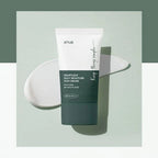 Anua Heartleaf Silky Moisture Sun Cream tube with product swatch in the background