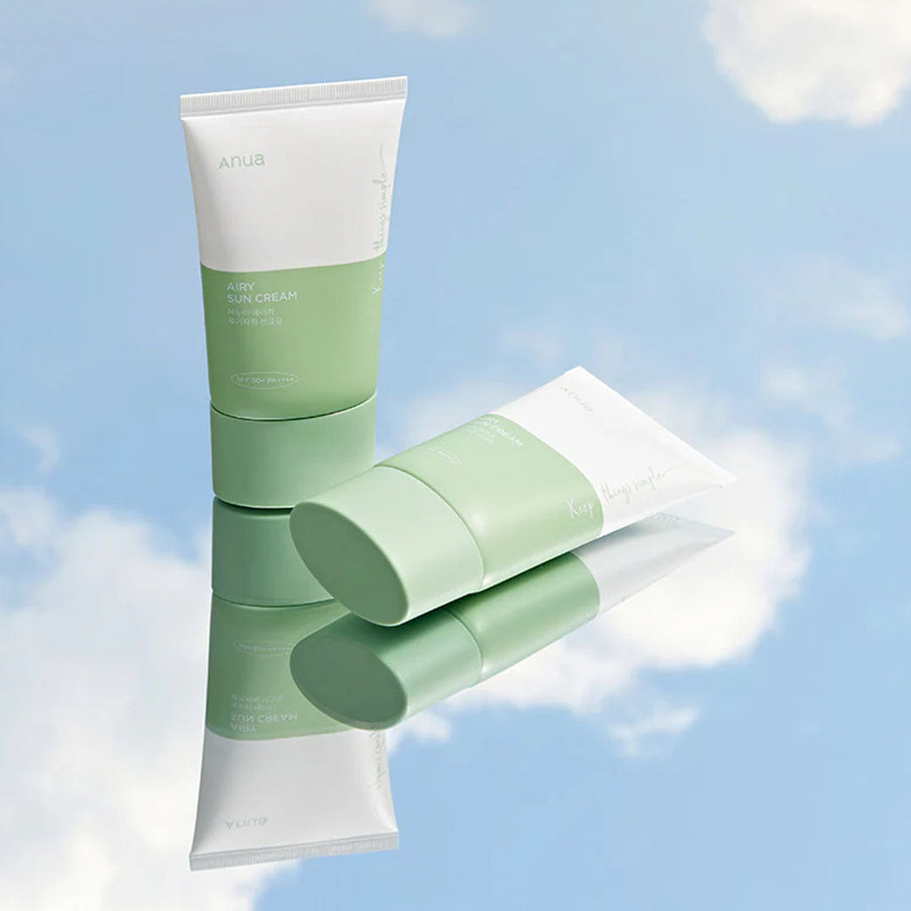 2 Anua Airy Sun Cream Renewed Version tubes on mirror surface