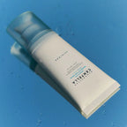 SKIN 1004 Madagascar Centella Hyalu-Cica Water-Fit Sun Serum tube on a blue surface