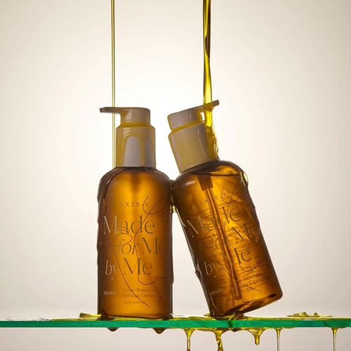 AXIS-Y Biome Resetting Moringa Cleansing Oil bottles drenched in product