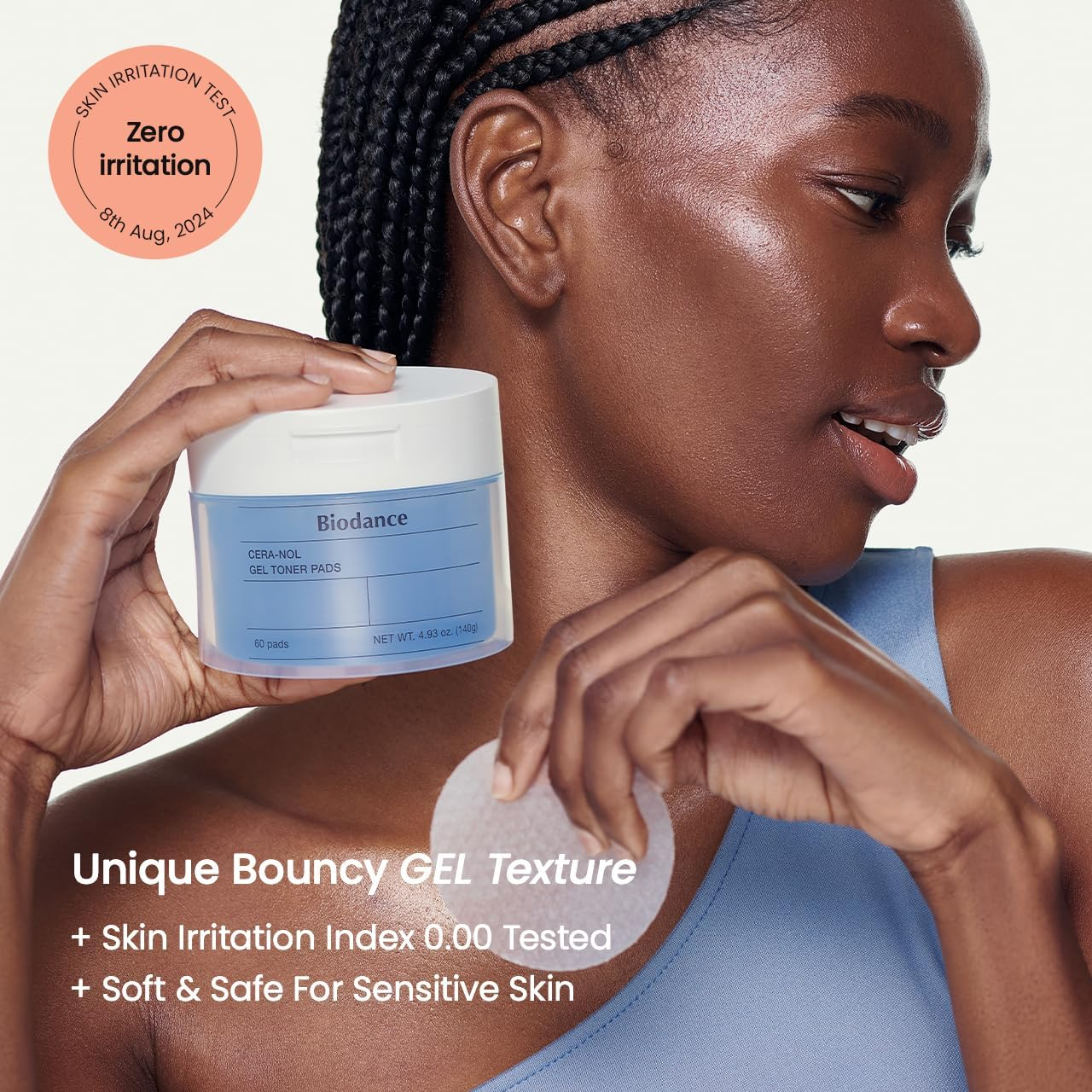 a woman holding BIODANCE Cera-nol Gel Toner Pads (60 Pads/140g) in her hand