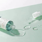 open bottle of AXIS-Y Artichoke Intensive Skin Barrier Ampoule with dropper