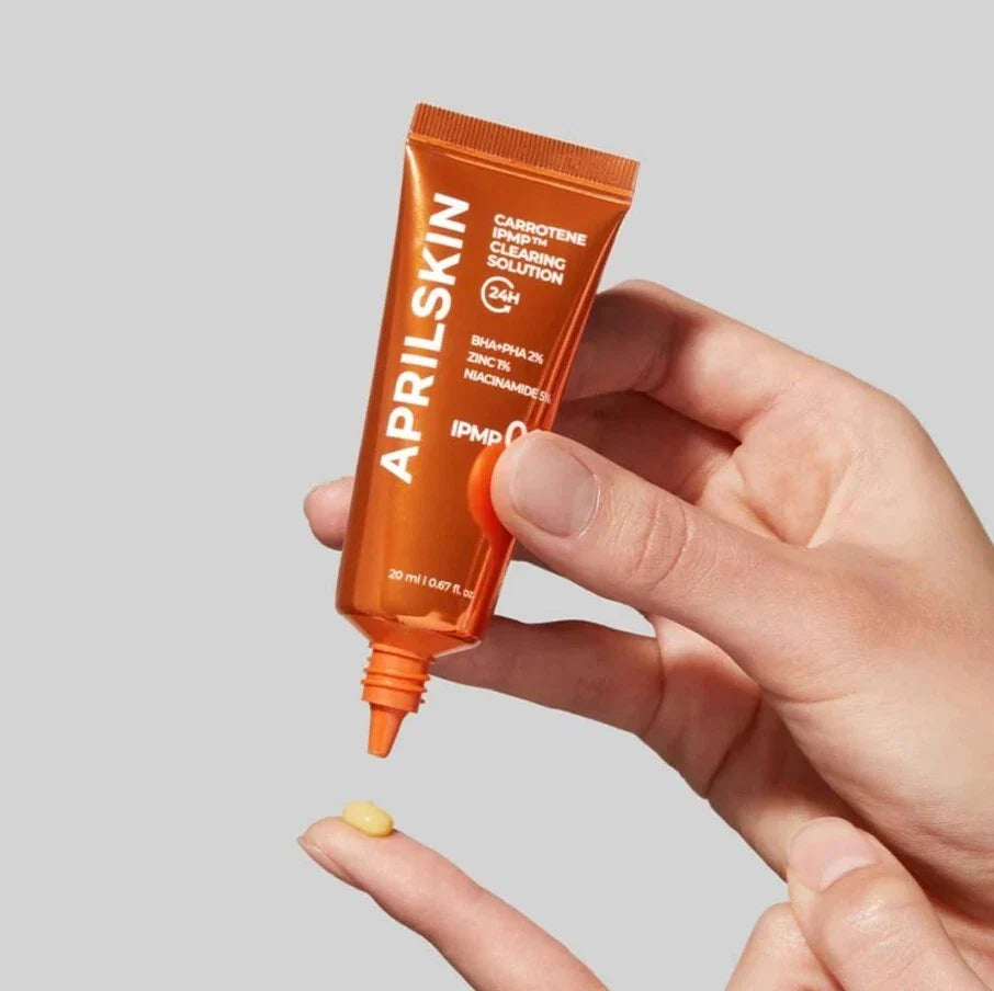hand holding APRILSKIN Carrotene IPMP Clearing Solution tube